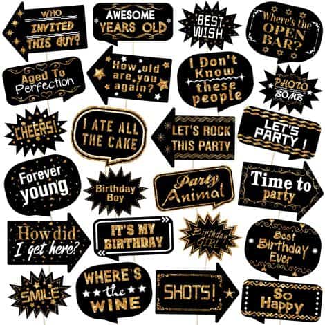 Gold and black birthday photo booth props with sticks, funny signs for selfie and party decorations.